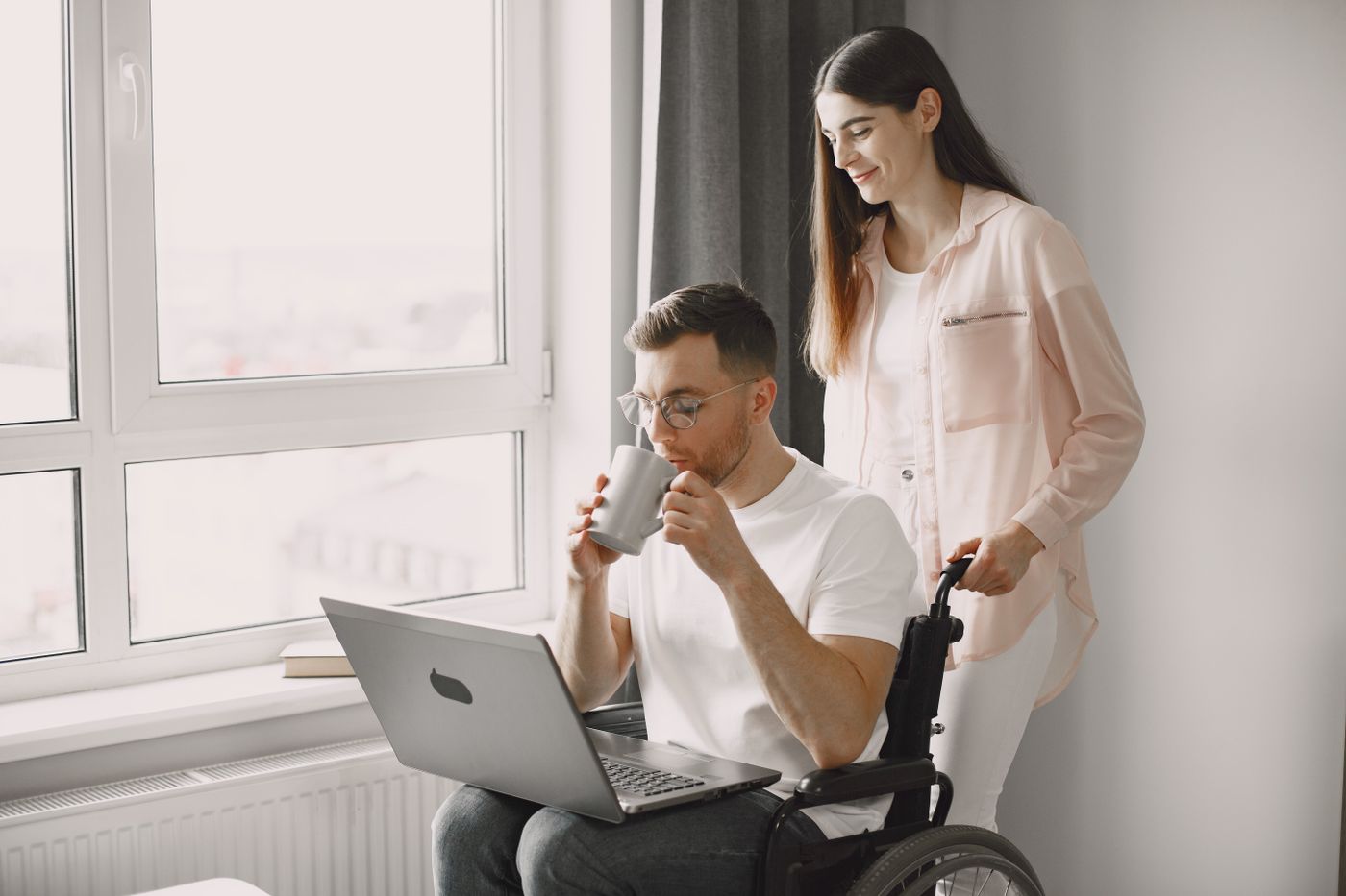 A support worker sharing a tablet with a family at home