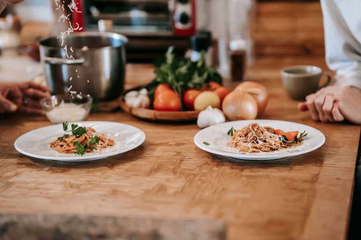 A support worker and participant preparing a meal together at home