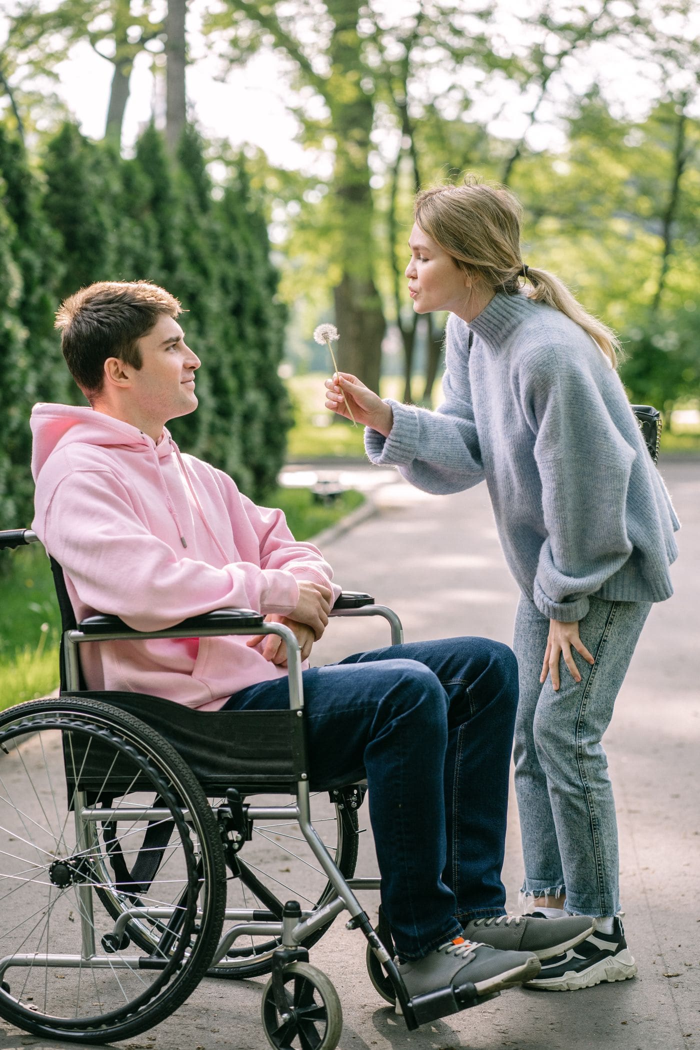 A support worker helping a woman in a wheelchair at home